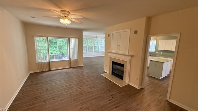 2019 River Pearl Way, Chesapeake, VA 23321 - unfurnished living room featuring ceiling fan, dark wood-style flooring, baseboards, a premium fireplace, and a sink