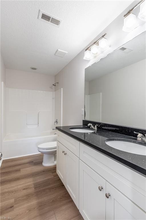 429 Draper Dr, Norfolk, VA 23505 - bathroom with toilet, double vanity, shower / bathtub combination, wood finished floors, and a textured ceiling