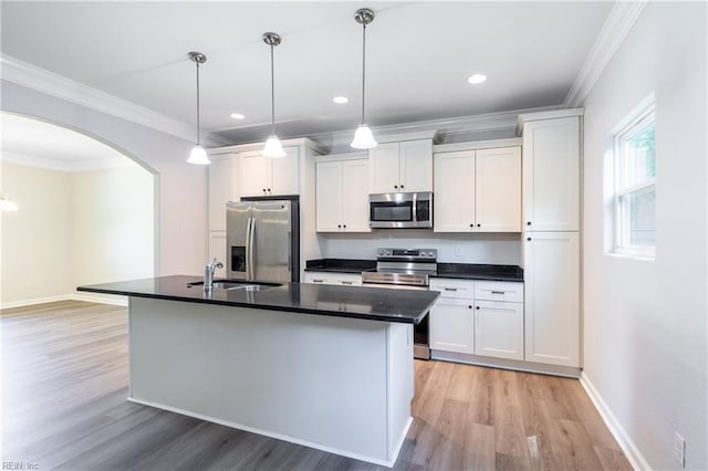 429 Draper Dr, Norfolk, VA 23505 - kitchen with stainless steel appliances, arched walkways, light wood-style floors, dark countertops, and white cabinetry