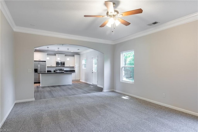 429 Draper Dr, Norfolk, VA 23505 - unfurnished living room featuring light colored carpet, arched walkways, ornamental molding, and baseboards