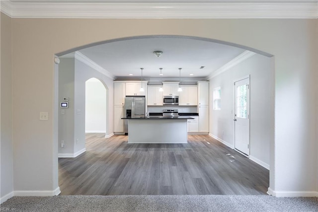 429 Draper Dr, Norfolk, VA 23505 - kitchen featuring stainless steel appliances, crown molding, dark countertops, arched walkways, and white cabinetry