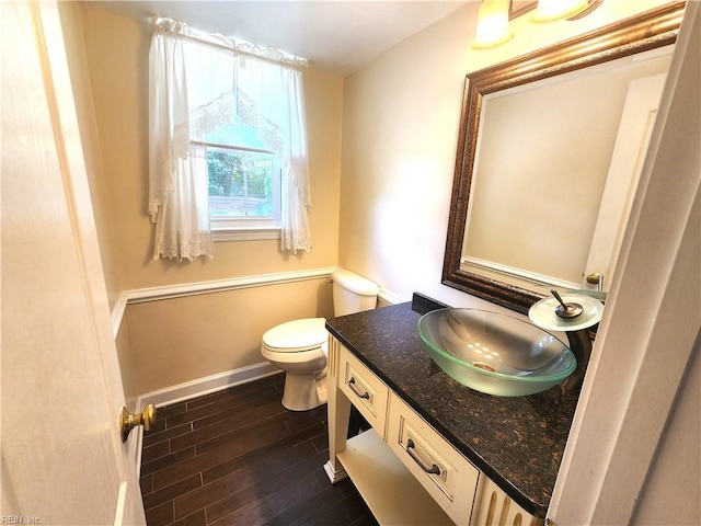 5097 Rochelle Rd, Virginia Beach, VA 23464 - half bath with toilet, vanity, wood finished floors, and baseboards