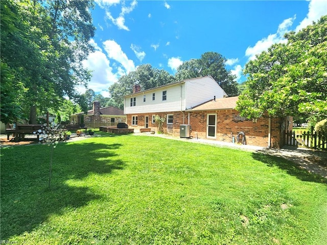 5097 Rochelle Rd, Virginia Beach, VA 23464 - back of property featuring brick siding, cooling unit, a chimney, and a patio