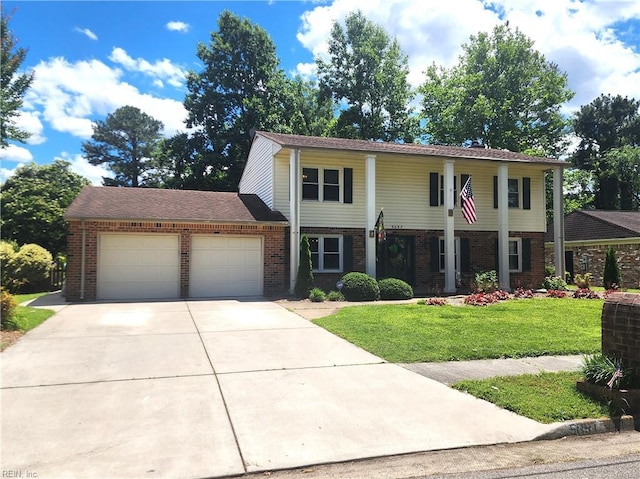 5097 Rochelle Rd, Virginia Beach, VA 23464 - view of front facade with brick siding, an attached garage, a front yard, and concrete driveway