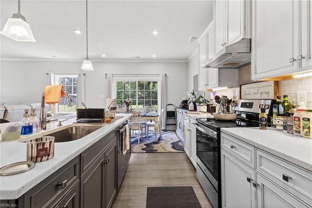 110 Georgia Dr, Elizabeth City, NC 27909 - kitchen with stainless steel range with electric stovetop, under cabinet range hood, white cabinets, ornamental molding, and pendant lighting