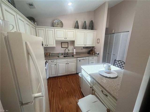 240 Dockside Dr Unit C, Hampton, VA 23669 - kitchen featuring white appliances, a sink, dark wood-type flooring, white cabinetry, and light stone counters