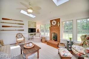 337 Juniper Cove Ln, Bohannon, VA 23021 - living area with a skylight, a brick fireplace, ceiling fan, and lofted ceiling