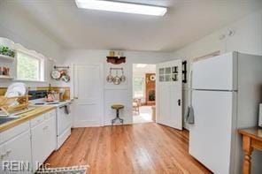 337 Juniper Cove Ln, Bohannon, VA 23021 - kitchen with freestanding refrigerator, light wood-style floors, and white cabinetry
