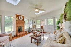 337 Juniper Cove Ln, Bohannon, VA 23021 - living area featuring a skylight, vaulted ceiling, ceiling fan, and a fireplace