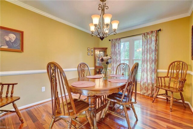 7 Saint Francis Dr, Newport News, VA 23602 - dining area with wood finished floors, crown molding, a chandelier, and baseboards