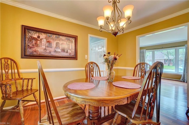 7 Saint Francis Dr, Newport News, VA 23602 - dining area with crown molding, a chandelier, and wood finished floors