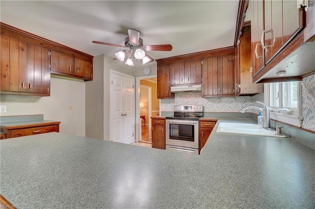 7 Saint Francis Dr, Newport News, VA 23602 - kitchen with electric stove, a sink, brown cabinets, ceiling fan, and under cabinet range hood