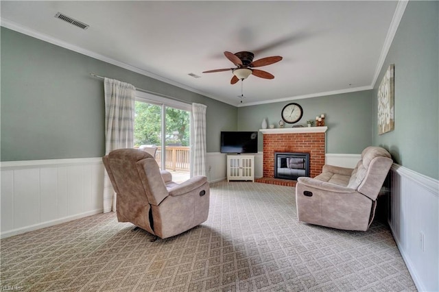 7 Saint Francis Dr, Newport News, VA 23602 - carpeted living room with ornamental molding, ceiling fan, wainscoting, a fireplace, and a decorative wall