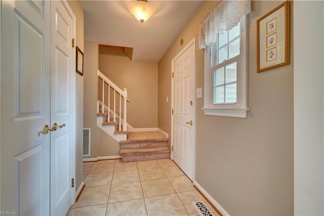 7 Saint Francis Dr, Newport News, VA 23602 - foyer entrance with stairs, light tile patterned flooring, and baseboards