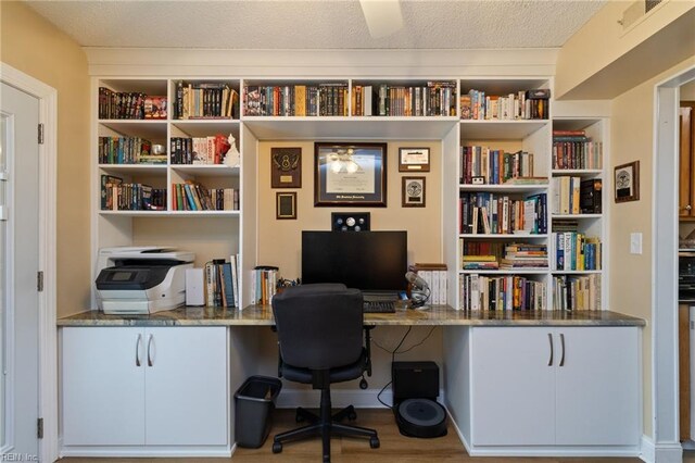 709 Roosevelt Ave, Virginia Beach, VA 23452 - home office with built in study area, wood finished floors, and a textured ceiling