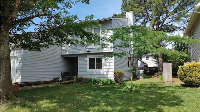709 Roosevelt Ave, Virginia Beach, VA 23452 - rear view of house with a yard and a chimney