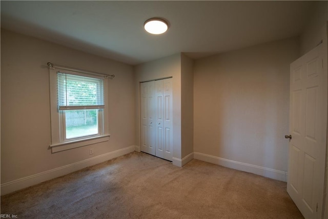 3032 Grandy Ave, Norfolk, VA 23509 - unfurnished bedroom with light carpet, baseboards, and a closet