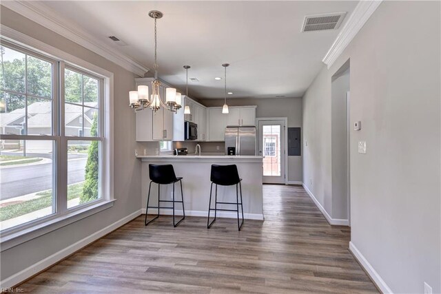 3545 Amberley Way, Williamsburg, VA 23188 - kitchen with stainless steel fridge with ice dispenser, a chandelier, healthy amount of natural light, a peninsula, and crown molding