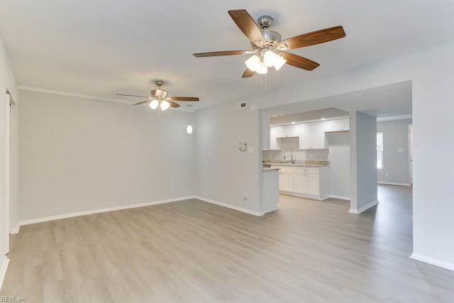 722 White Hall Ln, Virginia Beach, VA 23464 - unfurnished living room featuring ceiling fan, light wood-style flooring, baseboards, and a sink