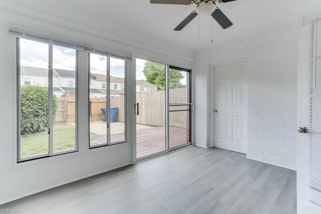 722 White Hall Ln, Virginia Beach, VA 23464 - empty room with wood finished floors, ceiling fan, and brick wall