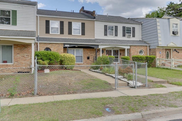 722 White Hall Ln, Virginia Beach, VA 23464 - townhome / multi-family property featuring a fenced front yard, covered porch, a gate, and brick siding
