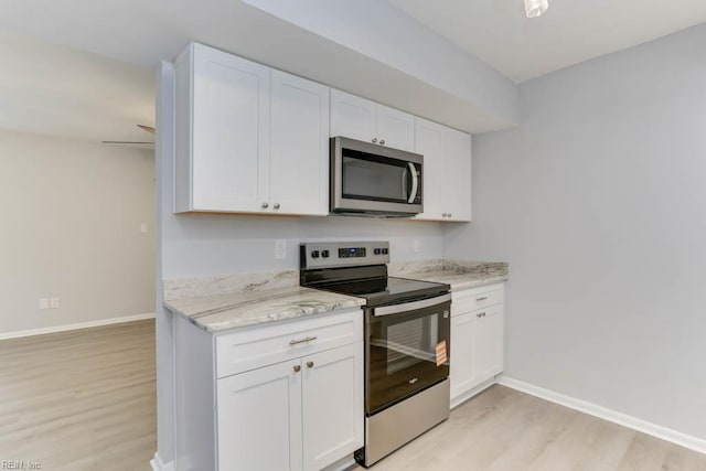 722 White Hall Ln, Virginia Beach, VA 23464 - kitchen featuring stainless steel appliances, light wood finished floors, white cabinetry, and baseboards