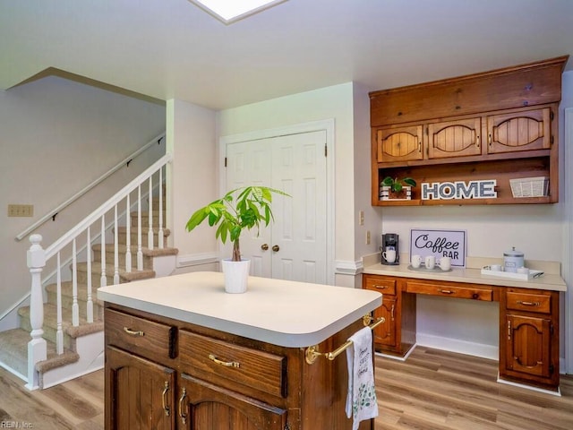 3124 Douglas Rd, Chesapeake, VA 23322 - kitchen with light wood-type flooring, light countertops, brown cabinetry, open shelves, and a kitchen island