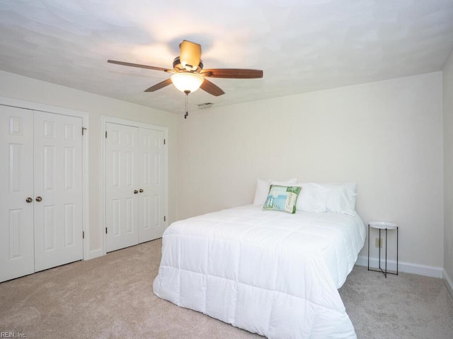 3124 Douglas Rd, Chesapeake, VA 23322 - carpeted bedroom with two closets, baseboards, and a ceiling fan