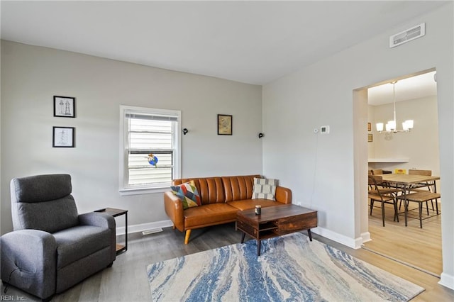 4 Hopkins St, Hampton, VA 23663 - living area with a chandelier, wood finished floors, and baseboards