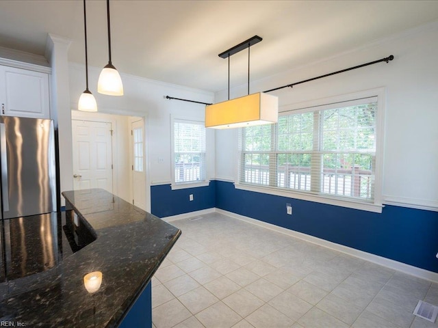 4604 Bellamy Ct, Virginia Beach, VA 23462 - kitchen featuring freestanding refrigerator, ornamental molding, light tile patterned flooring, dark stone countertops, and hanging light fixtures