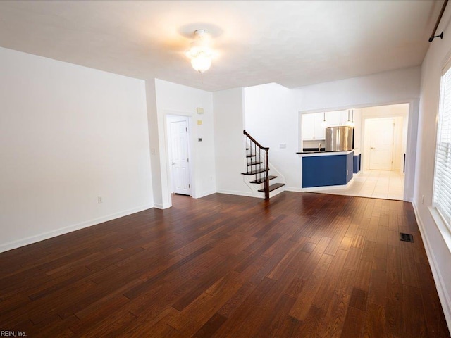 4604 Bellamy Ct, Virginia Beach, VA 23462 - unfurnished living room with stairway, dark wood-type flooring, and baseboards