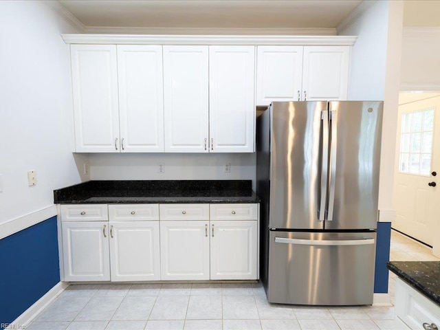4604 Bellamy Ct, Virginia Beach, VA 23462 - kitchen with freestanding refrigerator, white cabinets, dark stone counters, light tile patterned flooring, and crown molding