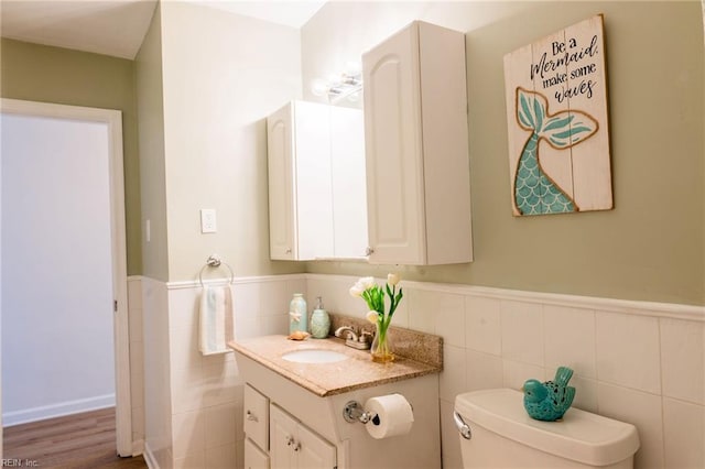 4505 Hessian Ct, Virginia Beach, VA 23462 - half bath featuring tile walls, toilet, vanity, and a wainscoted wall
