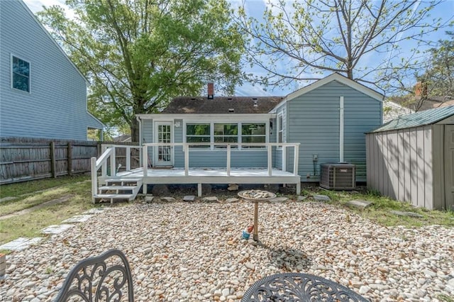 858 47th St, Norfolk, VA 23508 - rear view of house featuring a deck, a fenced backyard, central AC unit, a shingled roof, and a chimney