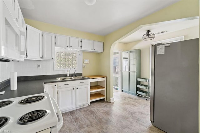 858 47th St, Norfolk, VA 23508 - kitchen with white appliances, a sink, white cabinetry, arched walkways, and dark countertops