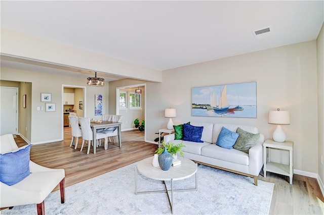 166 Mill Point Dr, Hampton, VA 23669 - living area with wood finished floors, baseboards, and a chandelier