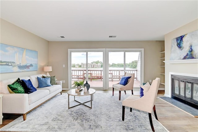 166 Mill Point Dr, Hampton, VA 23669 - living room with wood finished floors, a fireplace with flush hearth, and healthy amount of natural light