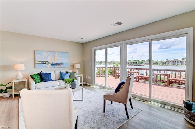166 Mill Point Dr, Hampton, VA 23669 - living area featuring light wood-type flooring, a water view, and baseboards