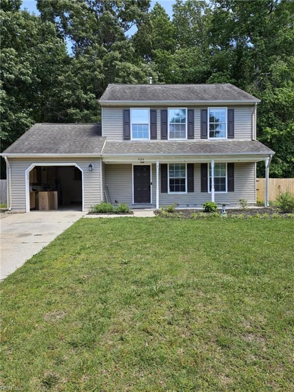 834 Haskins Dr, Suffolk, VA 23434 - view of front of house with an attached garage, driveway, view of scattered trees, and covered porch