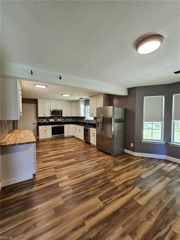 834 Haskins Dr, Suffolk, VA 23434 - kitchen with appliances with stainless steel finishes, butcher block counters, plenty of natural light, and dark wood finished floors