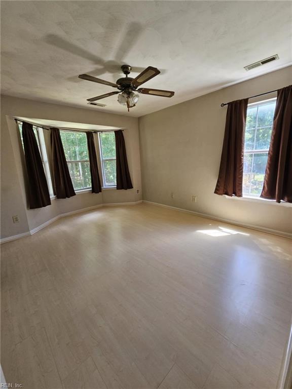 834 Haskins Dr, Suffolk, VA 23434 - unfurnished room featuring baseboards, a ceiling fan, and wood finished floors