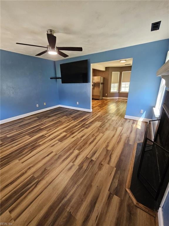 834 Haskins Dr, Suffolk, VA 23434 - empty room with wood finished floors, ceiling fan, baseboards, and a fireplace
