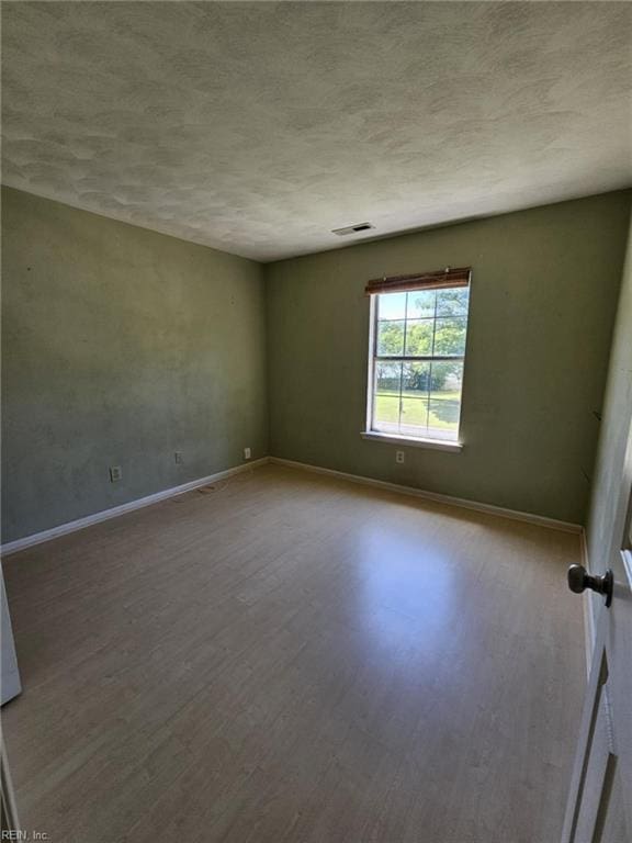 834 Haskins Dr, Suffolk, VA 23434 - unfurnished room with wood finished floors, baseboards, and a textured ceiling