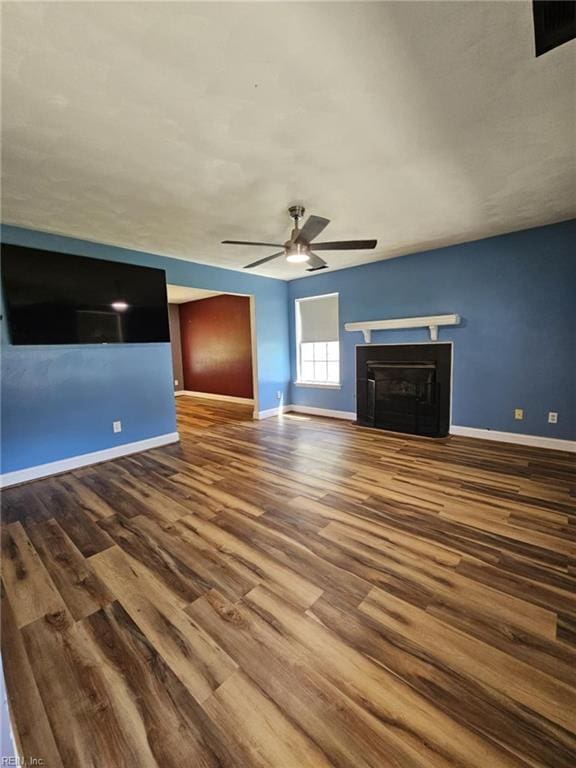834 Haskins Dr, Suffolk, VA 23434 - unfurnished living room with wood finished floors, ceiling fan, baseboards, and a fireplace