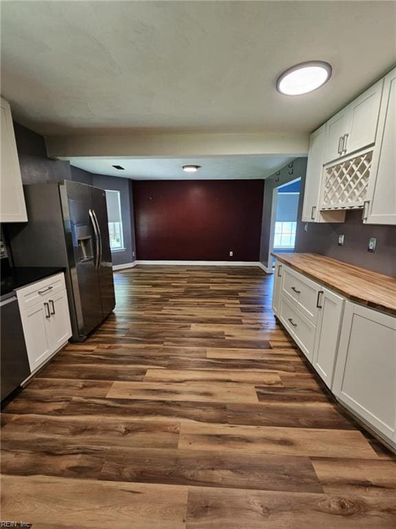 834 Haskins Dr, Suffolk, VA 23434 - kitchen with wood counters, dark wood-type flooring, white cabinetry, and baseboards