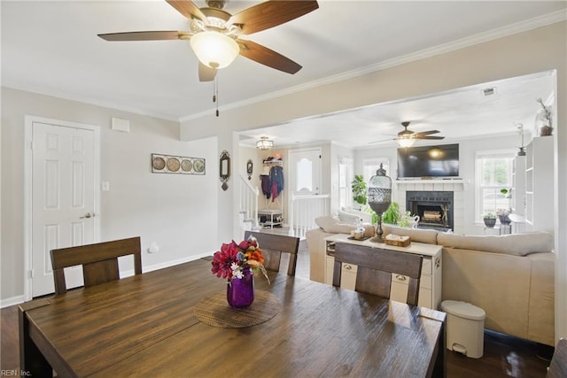 1765 Unicorn Dr, Virginia Beach, VA 23454 - dining room featuring ceiling fan, crown molding, dark wood-type flooring, baseboards, and a tiled fireplace