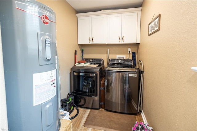 14387 Tucker Swamp Rd, Zuni, VA 23898 - laundry room featuring water heater, washing machine and dryer, cabinet space, wood finished floors, and a textured wall