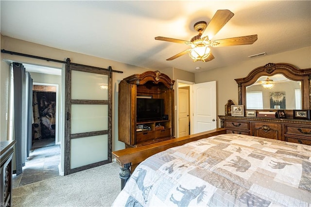 14387 Tucker Swamp Rd, Zuni, VA 23898 - bedroom with a barn door, carpet, and ceiling fan