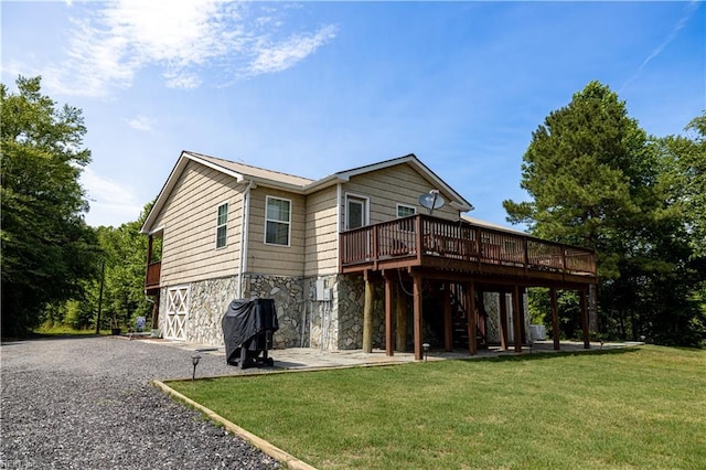 14387 Tucker Swamp Rd, Zuni, VA 23898 - rear view of house featuring stairs, a wooden deck, stone siding, a lawn, and a patio