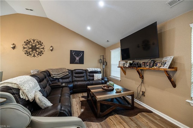 14387 Tucker Swamp Rd, Zuni, VA 23898 - living area with vaulted ceiling, wood finished floors, baseboards, and recessed lighting